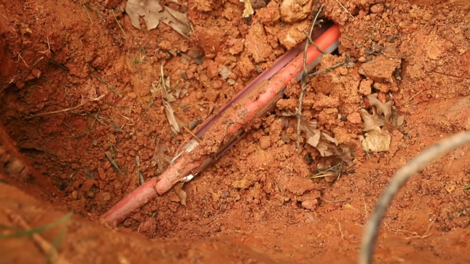 Copper water line exposed in a dug trench